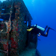 Diver exploring underwater shipwreck